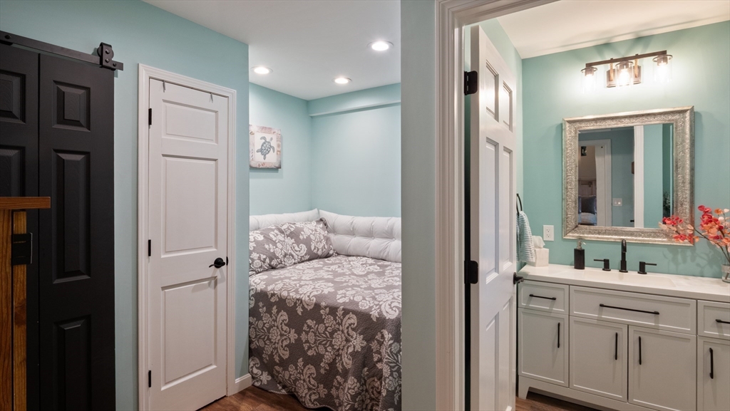 16 Sandy Cove Road Lunenburg, MA 01462 - Photo 33 of 38 a en suite bathroom with a granite countertop sink and a mirror