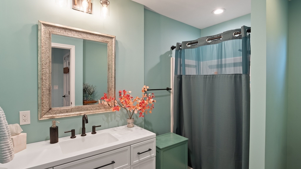 16 Sandy Cove Road Lunenburg, MA 01462 - Photo 35 of 38 a bathroom with a sink a mirror and a shower