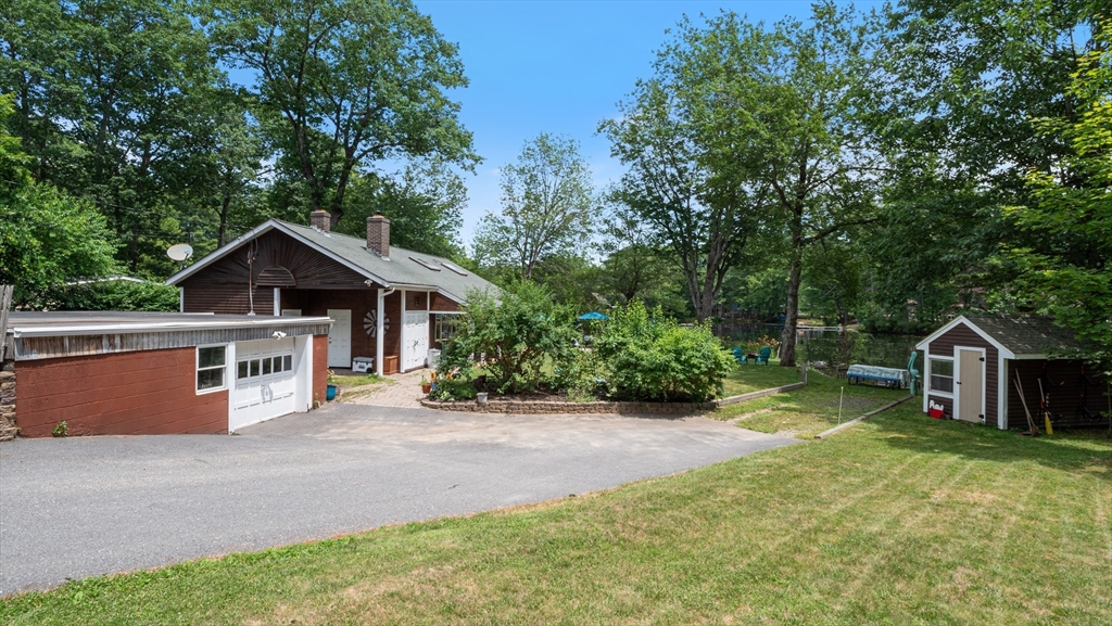 16 Sandy Cove Road Lunenburg, MA 01462 - Photo 4 of 38 a front view of house with yard and trees in the background