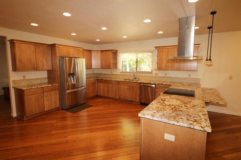 326 April Drive Merlin, OR 97532 - Photo 4 of 27 a kitchen with stainless steel appliances granite countertop a sink counter space cabinets and wooden floor