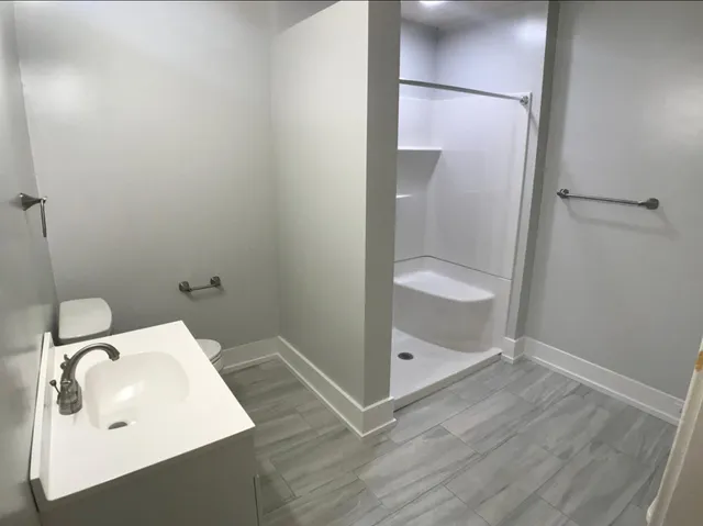 a bathroom with a sink and glass door