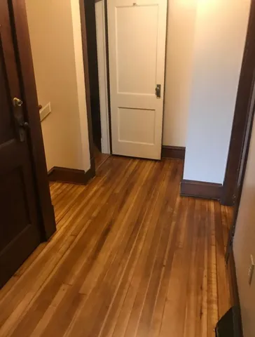 a view of front door with wooden floor