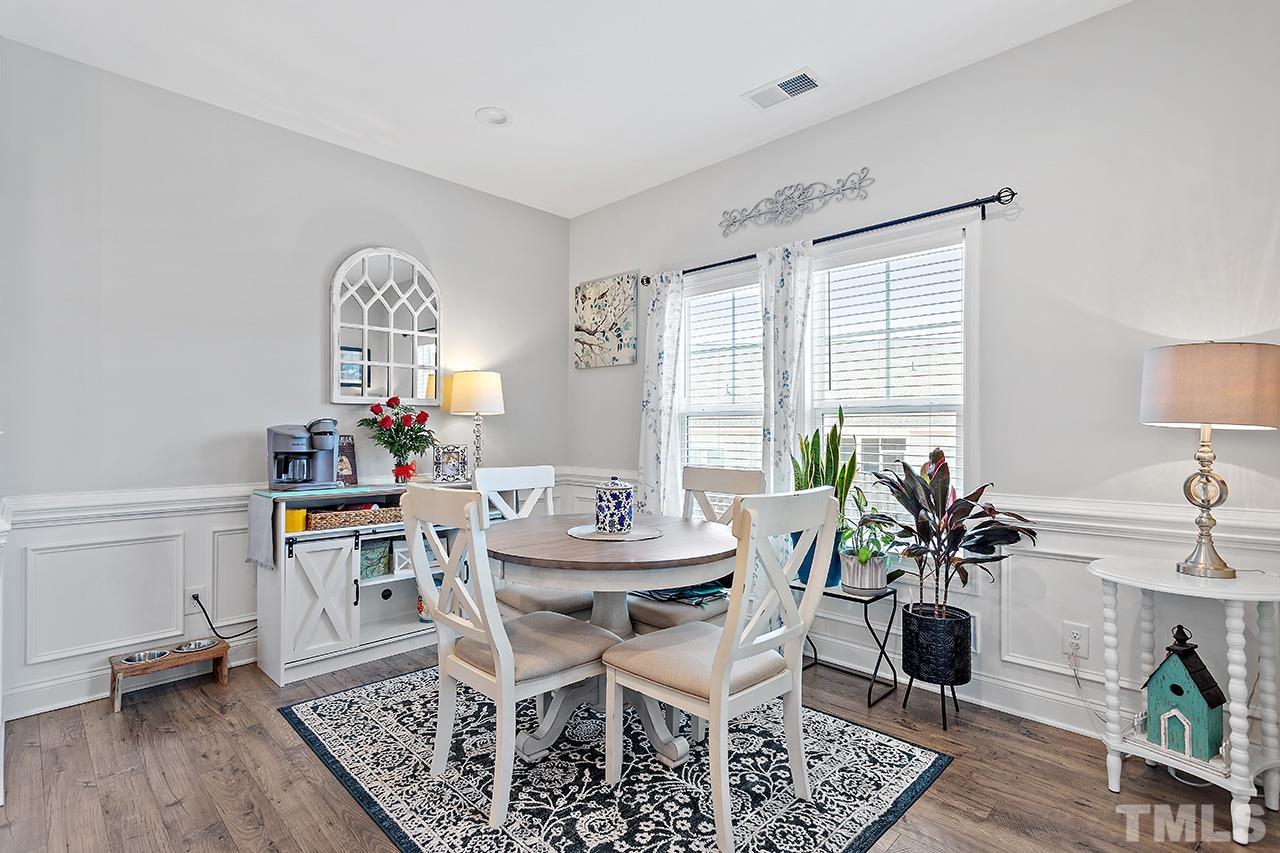196 Fairview Street Clayton, NC 27520 - Photo 11 of 21 a view of a dining room with furniture and wooden floor