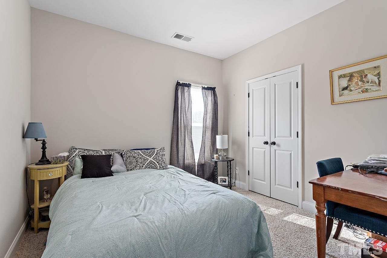 196 Fairview Street Clayton, NC 27520 - Photo 14 of 21 a bedroom with a bed and wooden floor