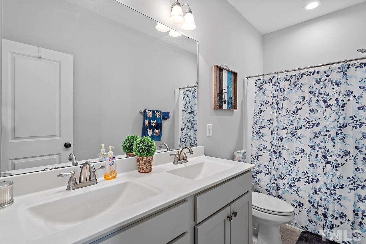 196 Fairview Street Clayton, NC 27520 - Photo 16 of 21 a bathroom with a sink toilet and a mirror