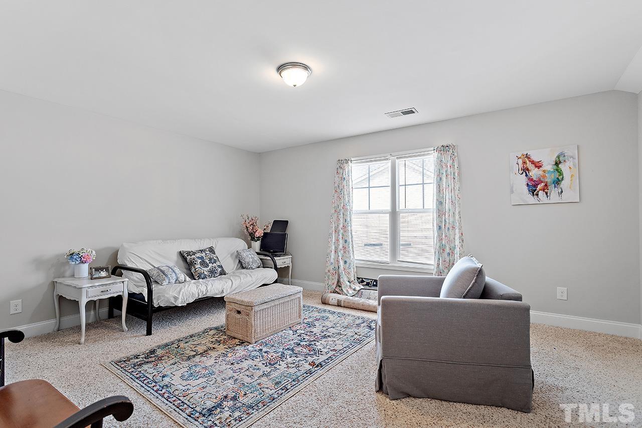 196 Fairview Street Clayton, NC 27520 - Photo 18 of 21 a living room with furniture and a rug