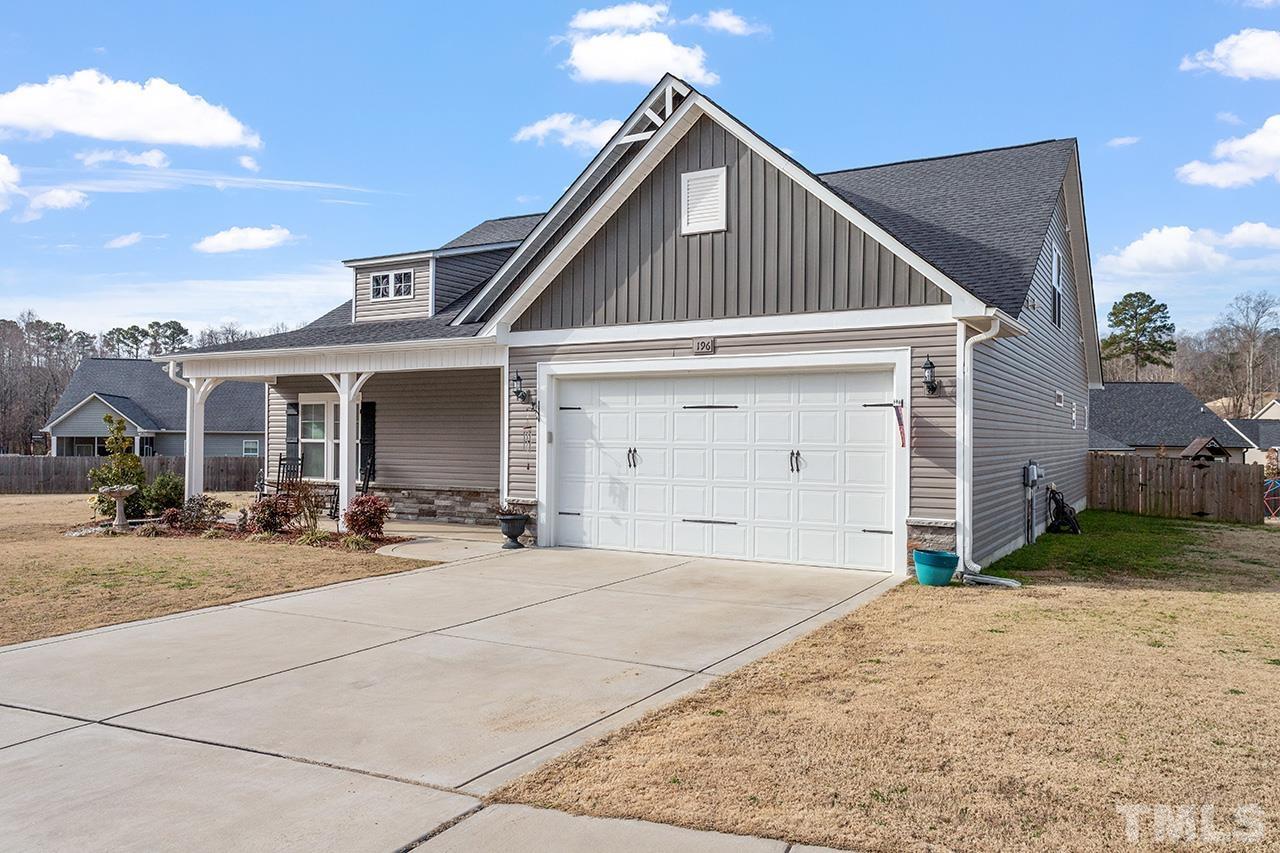 196 Fairview Street Clayton, NC 27520 - Photo 2 of 21 a front view of a house with yard and garage