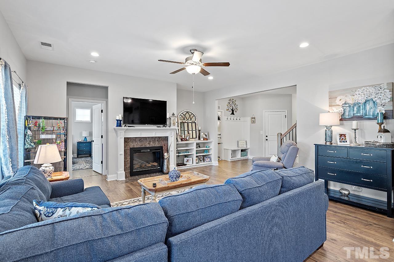 196 Fairview Street Clayton, NC 27520 - Photo 7 of 21 a living room with furniture a flat screen tv and a fireplace