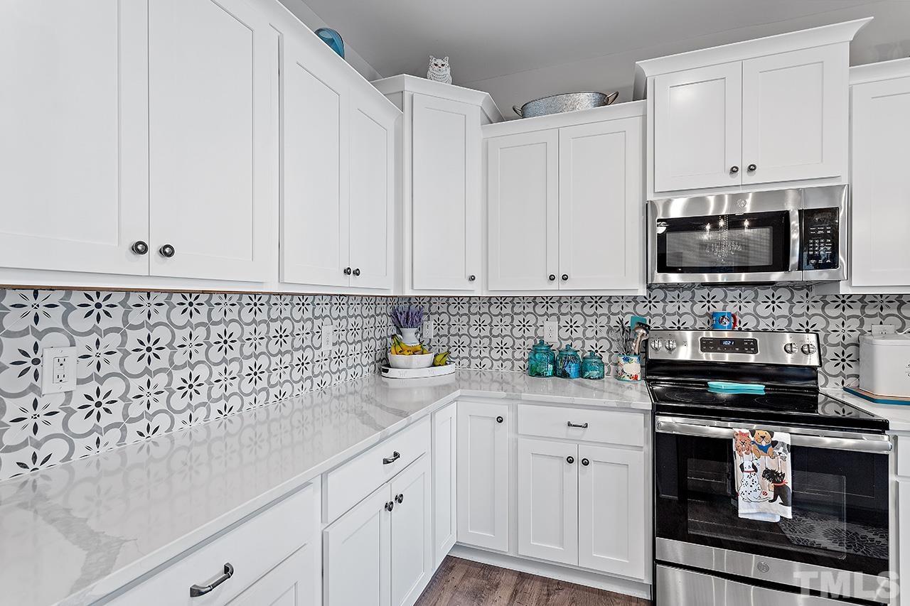 196 Fairview Street Clayton, NC 27520 - Photo 10 of 21 a kitchen with white cabinets and appliances