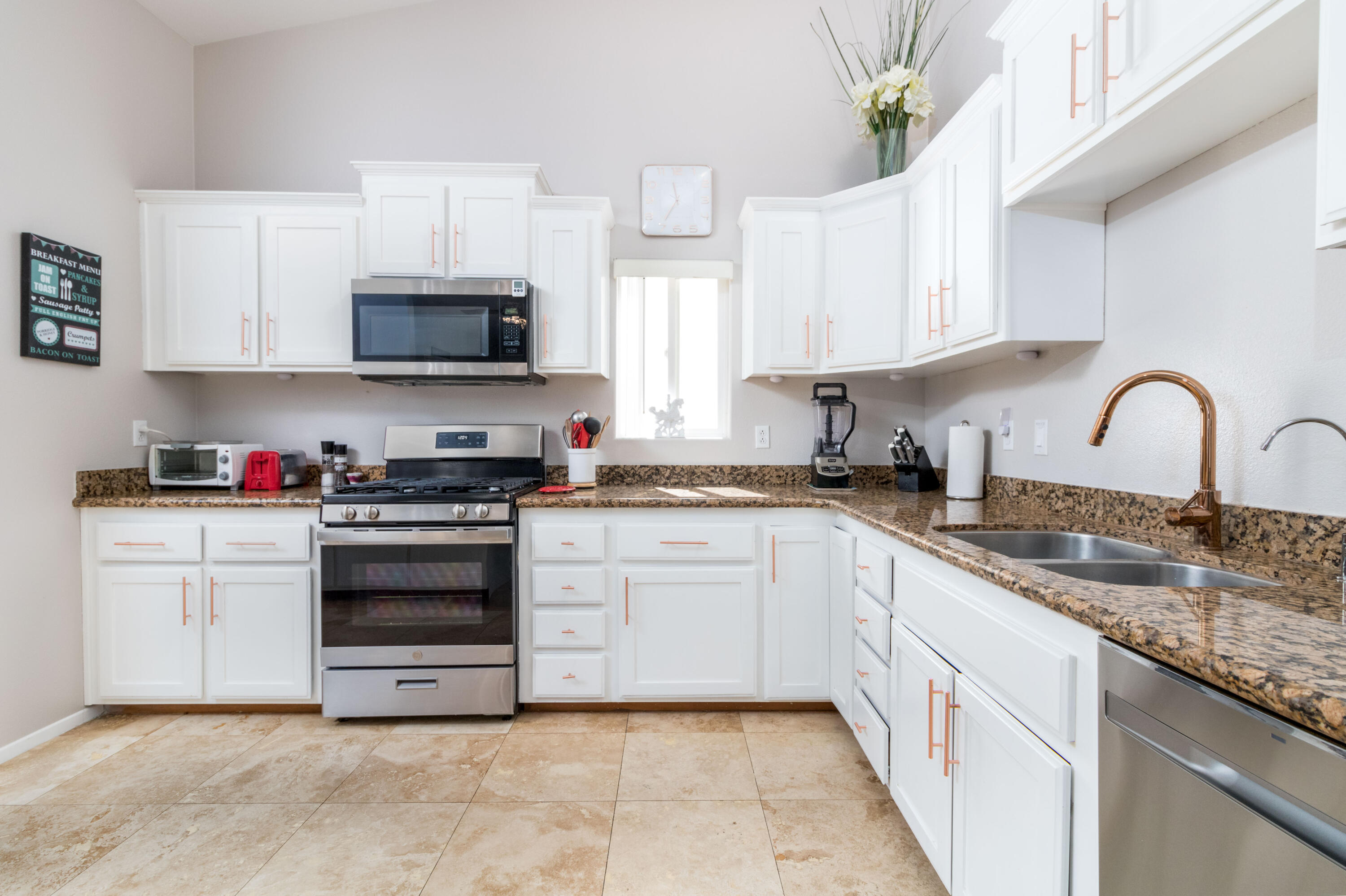 12753 Mountain View Road Desert Hot Springs, CA 92240 - Photo 18 of 45 a kitchen with cabinets stainless steel appliances and a sink