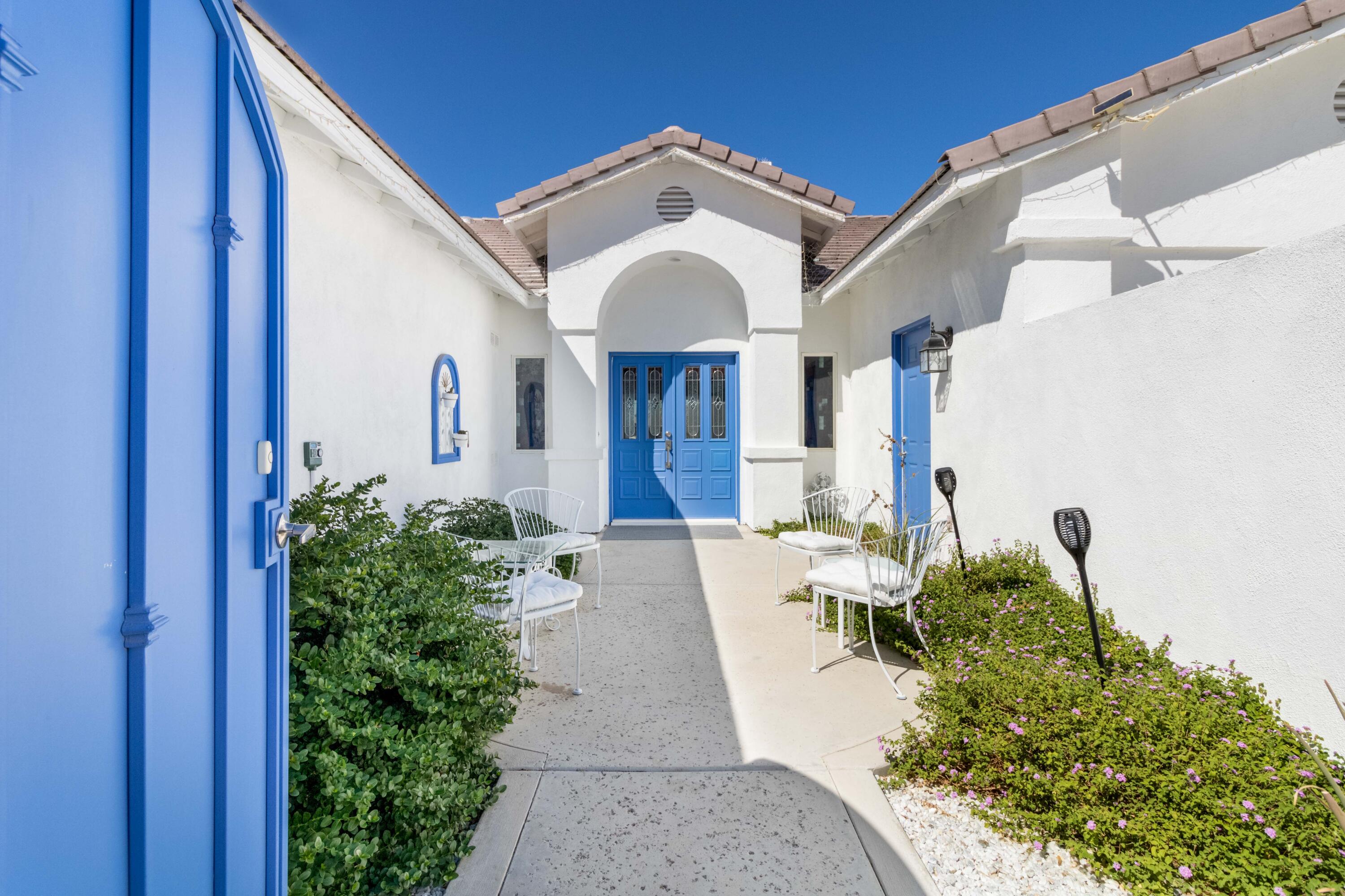 12753 Mountain View Road Desert Hot Springs, CA 92240 - Photo 2 of 45 a front view of a house with garden