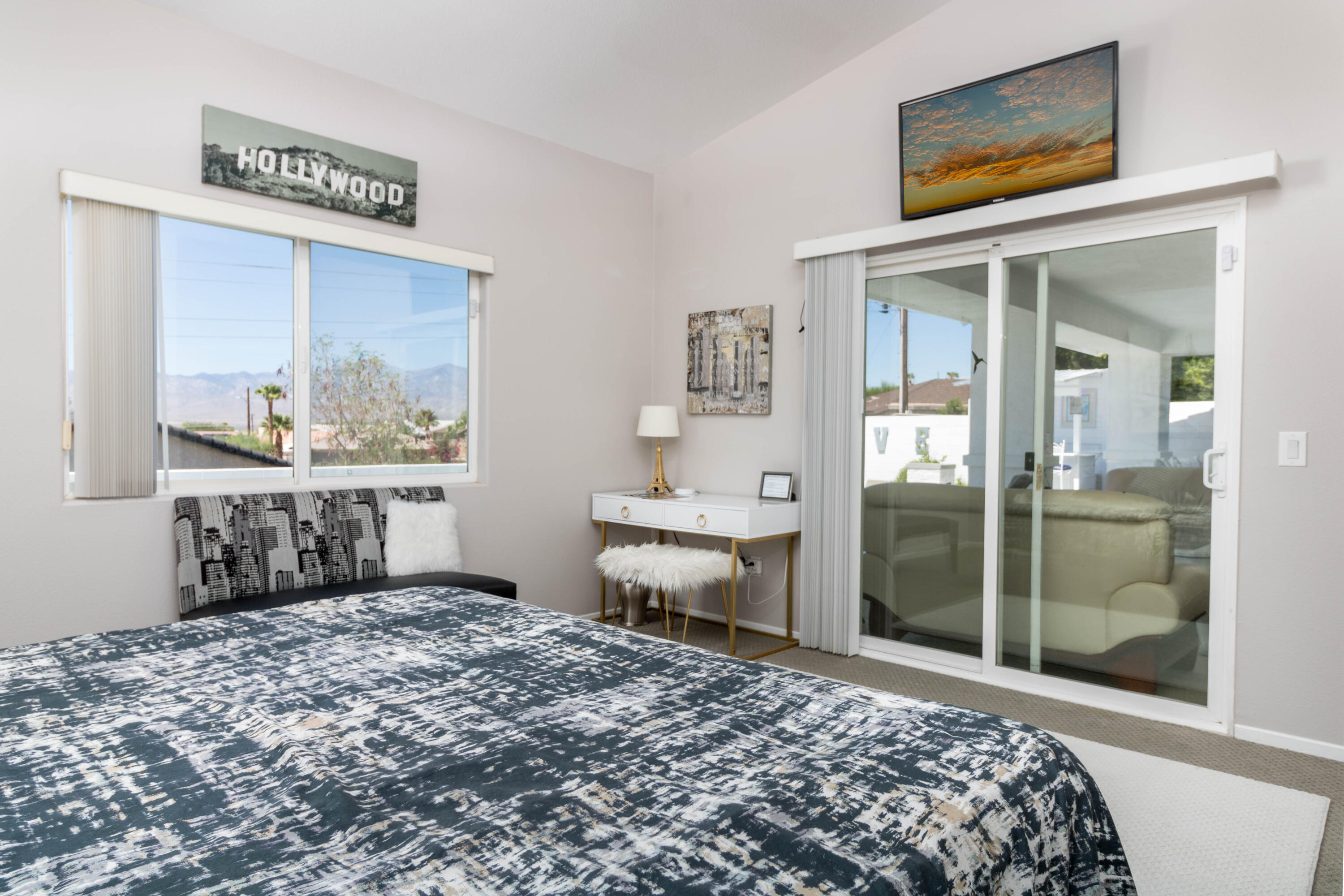 12753 Mountain View Road Desert Hot Springs, CA 92240 - Photo 22 of 45 a bedroom with a bed and a painting on the wall