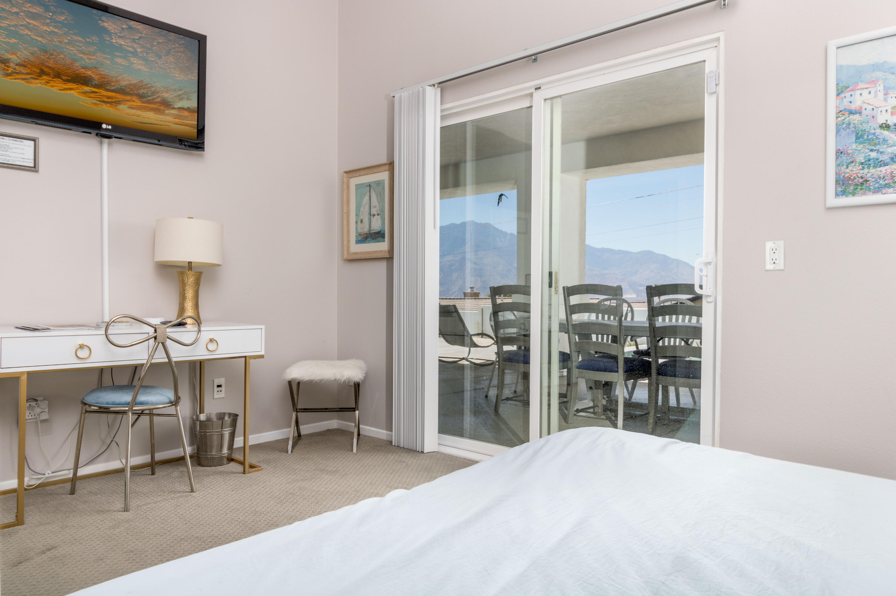 12753 Mountain View Road Desert Hot Springs, CA 92240 - Photo 32 of 45 a bedroom with a bed and a table in it