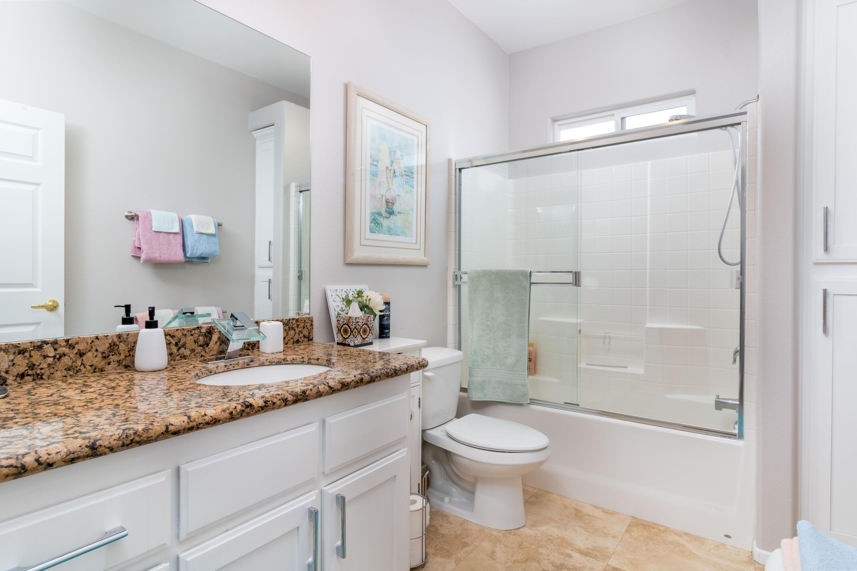 12753 Mountain View Road Desert Hot Springs, CA 92240 - Photo 33 of 45 a bathroom with a granite countertop sink a toilet and shower
