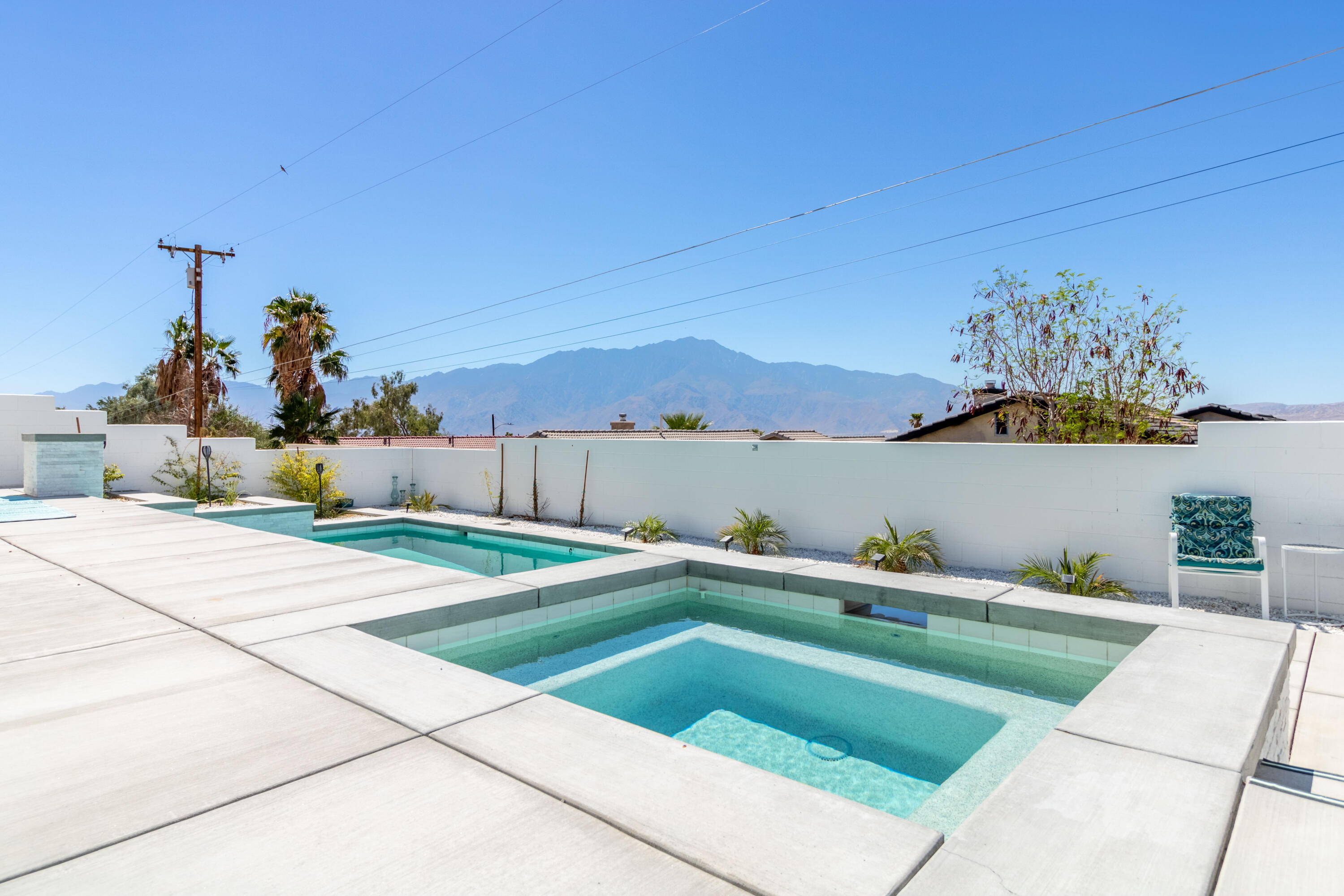 12753 Mountain View Road Desert Hot Springs, CA 92240 - Photo 41 of 45 a backyard of a house with table and chairs