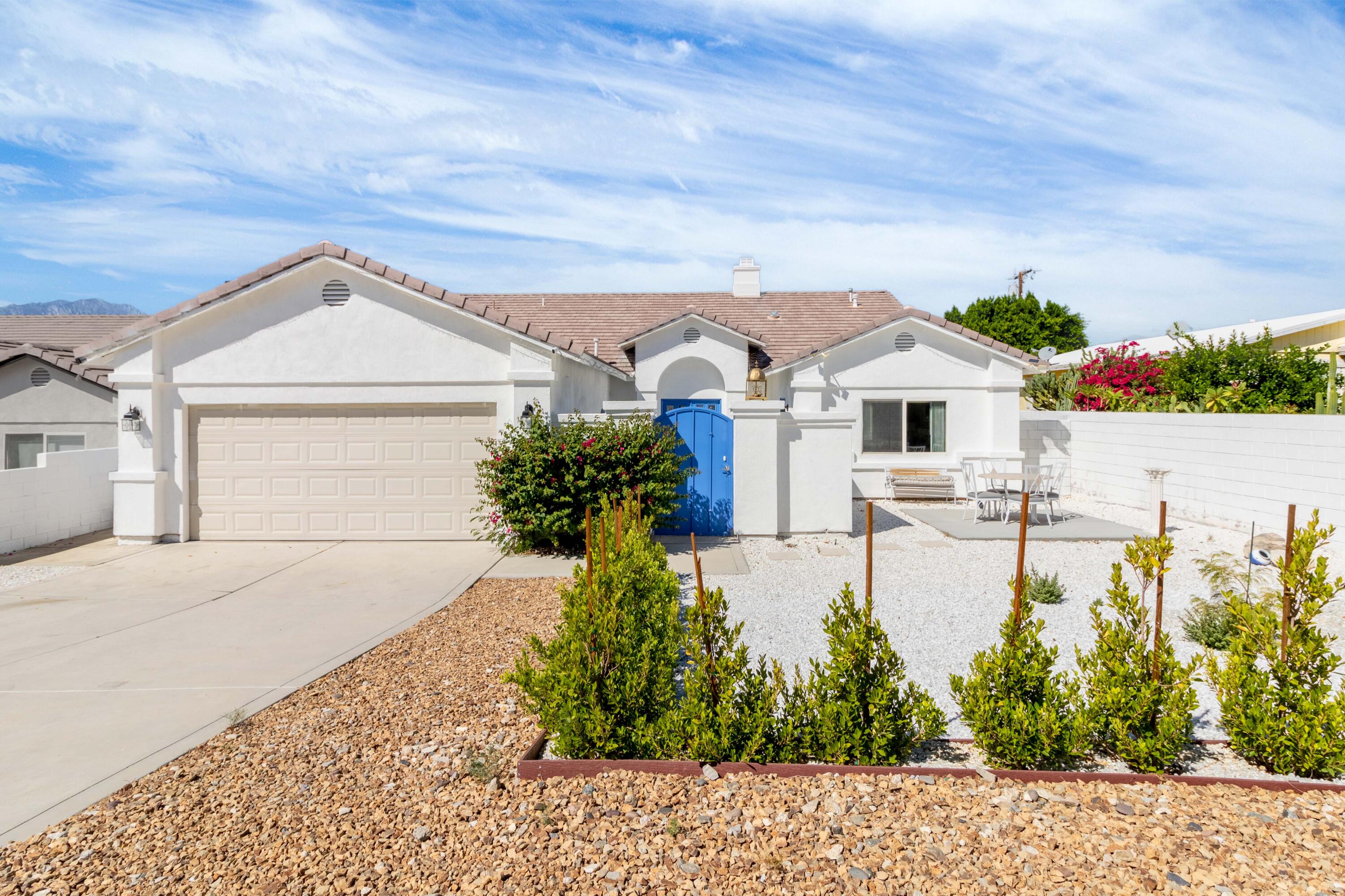 12753 Mountain View Road Desert Hot Springs, CA 92240 - Photo 6 of 45 a front view of a house with garden