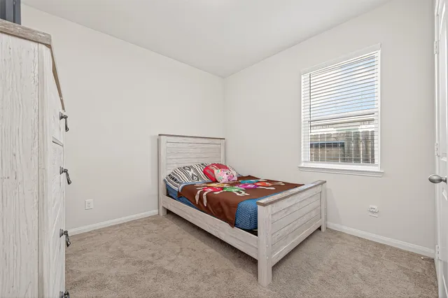 a bedroom with a bed and window