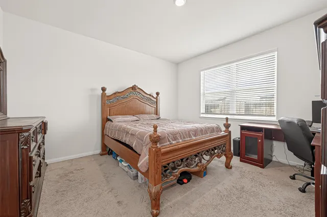 a bedroom with a bed and a desk