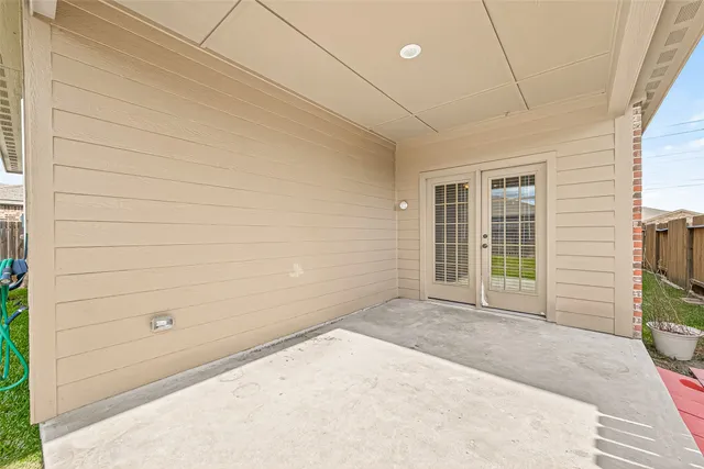 a view of a porch with wooden floor and a window
