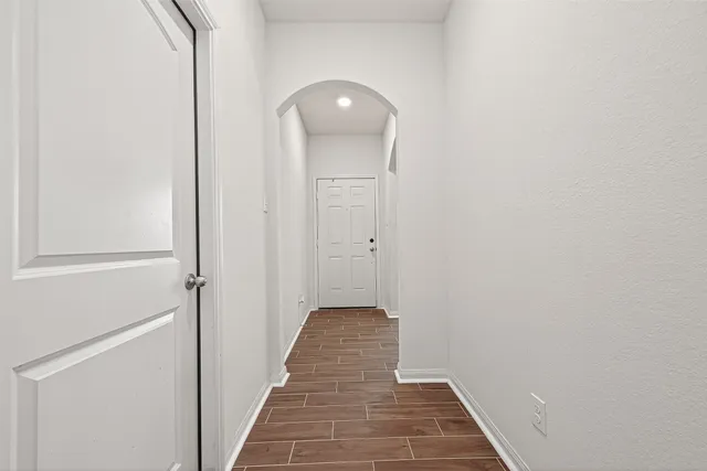 a view of a hallway with wooden floor