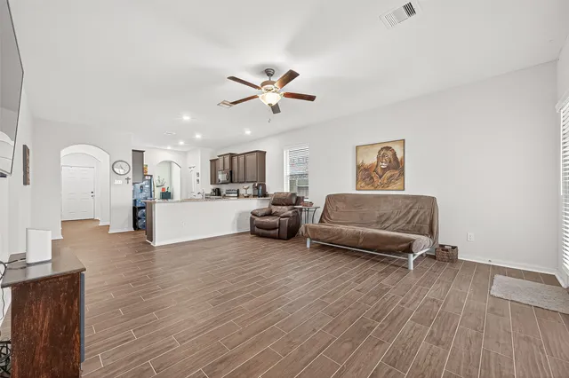 a living room with furniture and a wooden floor