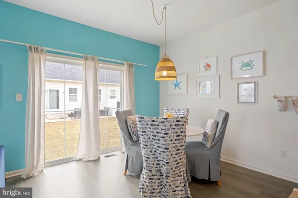 a view of a dining room with furniture and a window