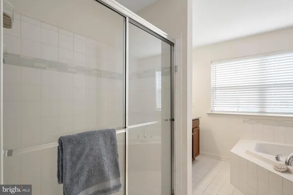 a bathroom with a granite countertop sink a large mirror and a window
