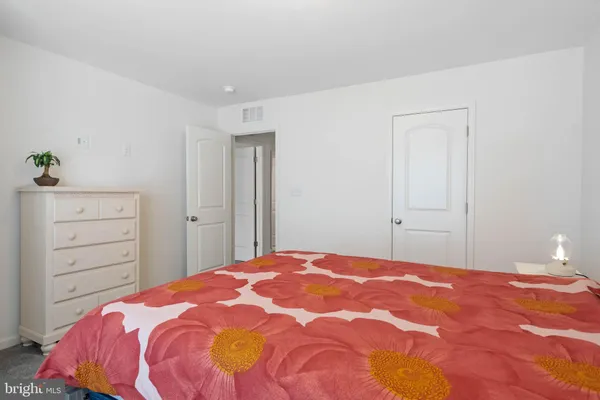 a bedroom with a bed a couch and a large window