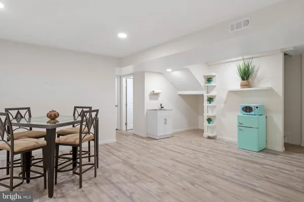 a view of a kitchen with dining room and wooden floor
