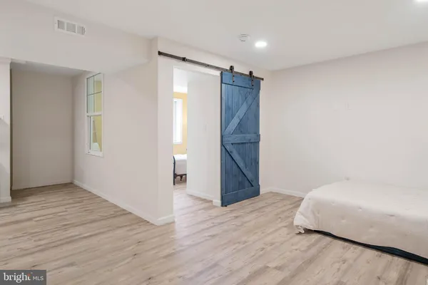a bedroom with a bed and window