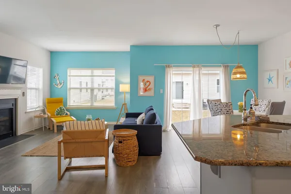 a dining room with furniture and a wooden floor