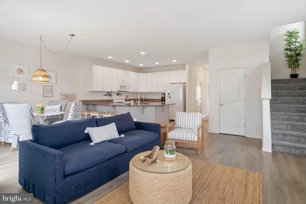 a view of a living room and kitchen with furniture