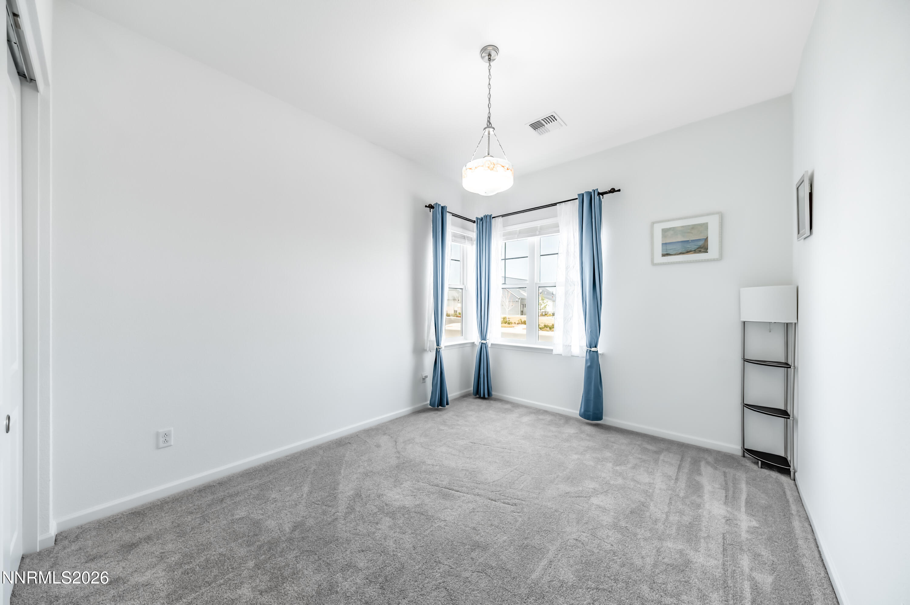 2402 Iron Square Drive Reno, NV 89521 - Photo 16 of 30 en empty room with windows and ceiling fan