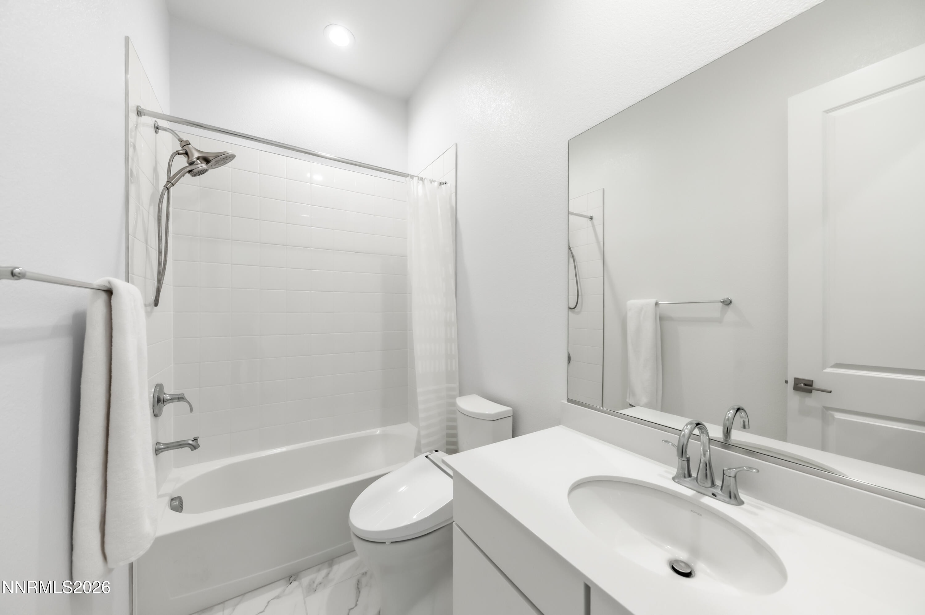 2402 Iron Square Drive Reno, NV 89521 - Photo 17 of 30 a bathroom with a sink mirror toilet and bathtub
