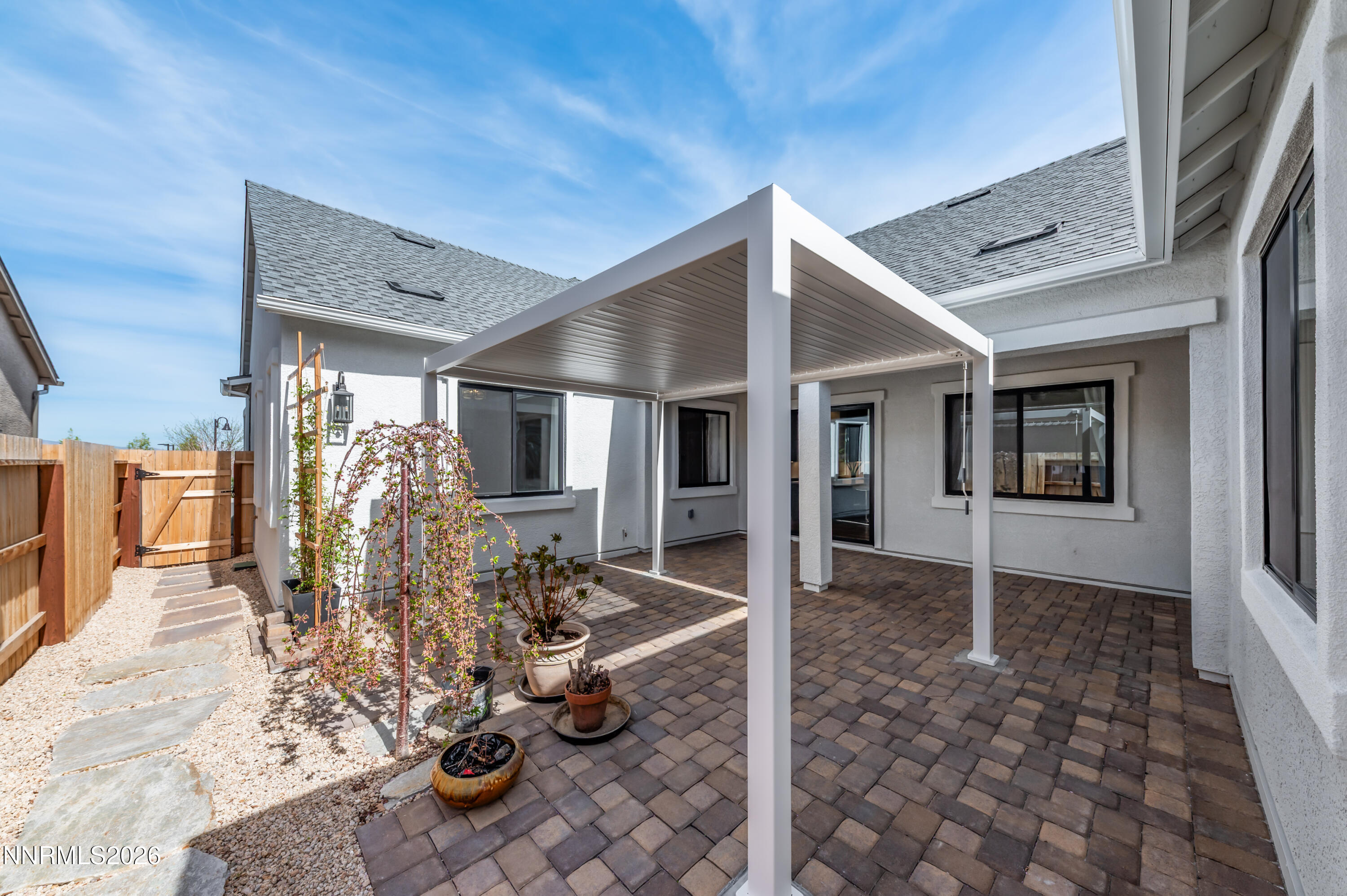 2402 Iron Square Drive Reno, NV 89521 - Photo 22 of 30 a view of a patio with table and chairs and potted plants