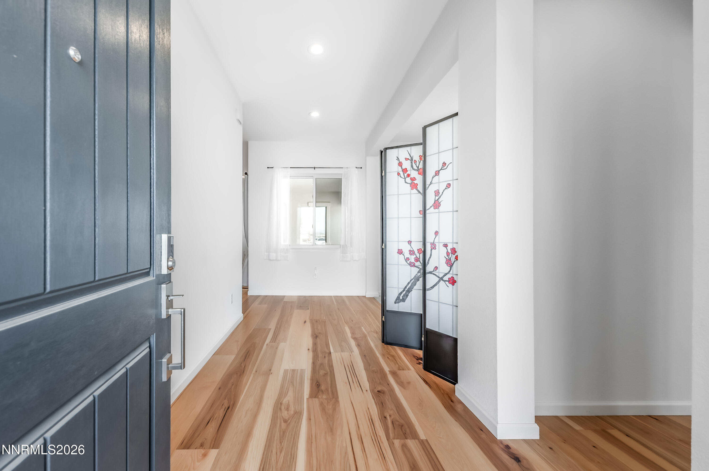 2402 Iron Square Drive Reno, NV 89521 - Photo 3 of 30 a view of a hallway with wooden floor and entryway