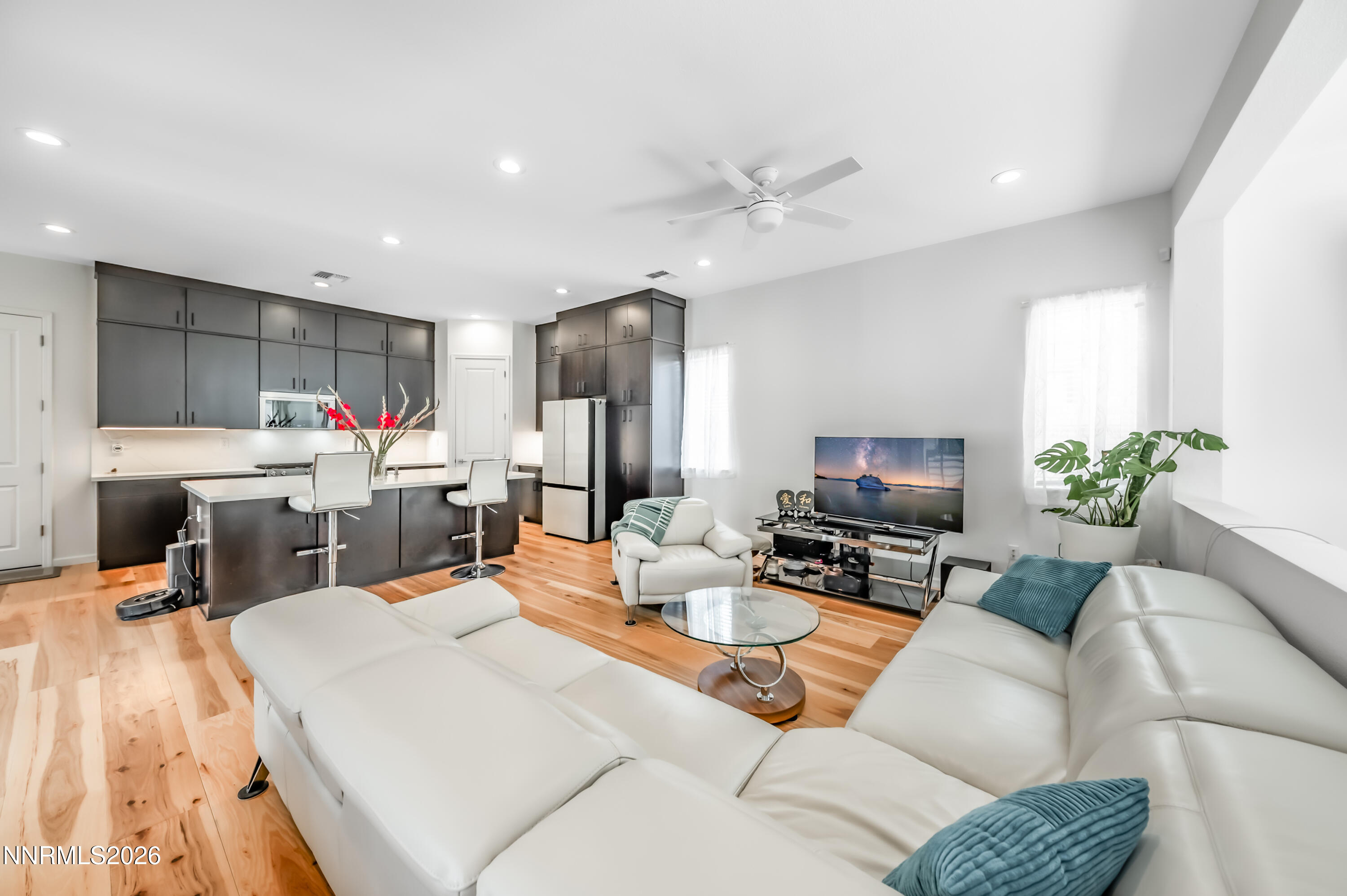 2402 Iron Square Drive Reno, NV 89521 - Photo 7 of 30 a living room with furniture a flat screen tv and kitchen view
