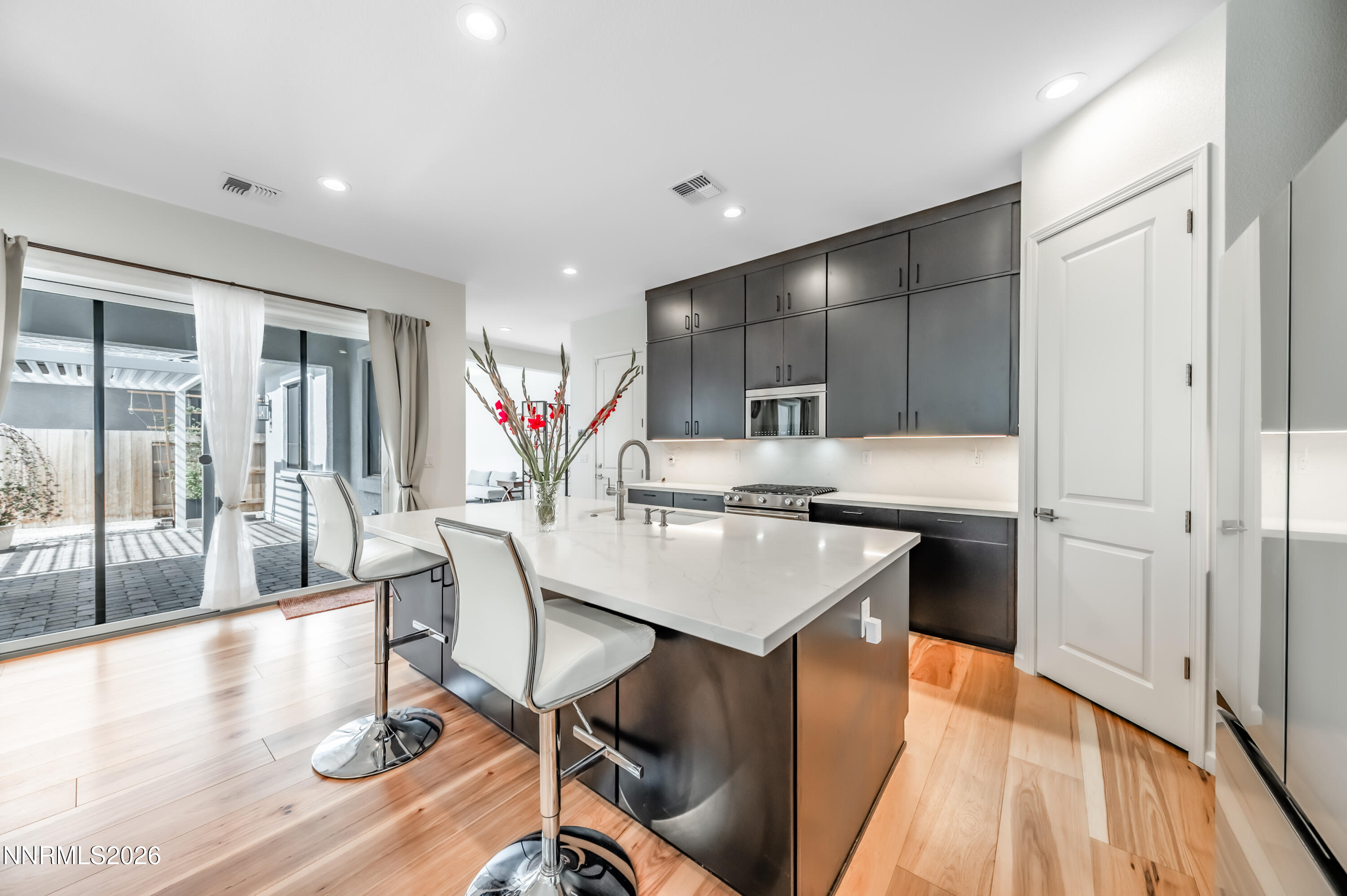 2402 Iron Square Drive Reno, NV 89521 - Photo 8 of 30 a kitchen with a sink cabinets and wooden floor