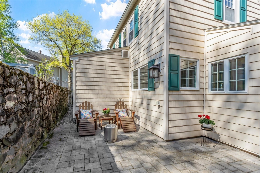 25 Naples Road Melrose, MA 02176 - Photo 21 of 36 a view of a patio with table and chairs and potted plants
