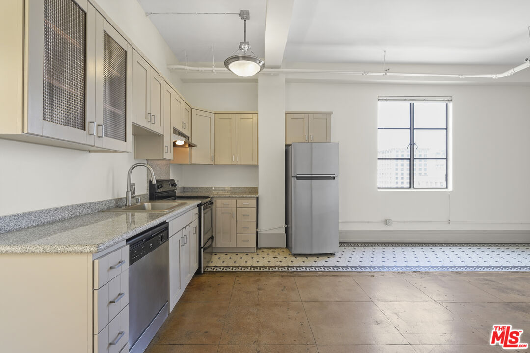 108 West 2nd Street, Unit 708 Los Angeles, CA 90012 - Photo 13 of 40 a kitchen with a sink stove and refrigerator