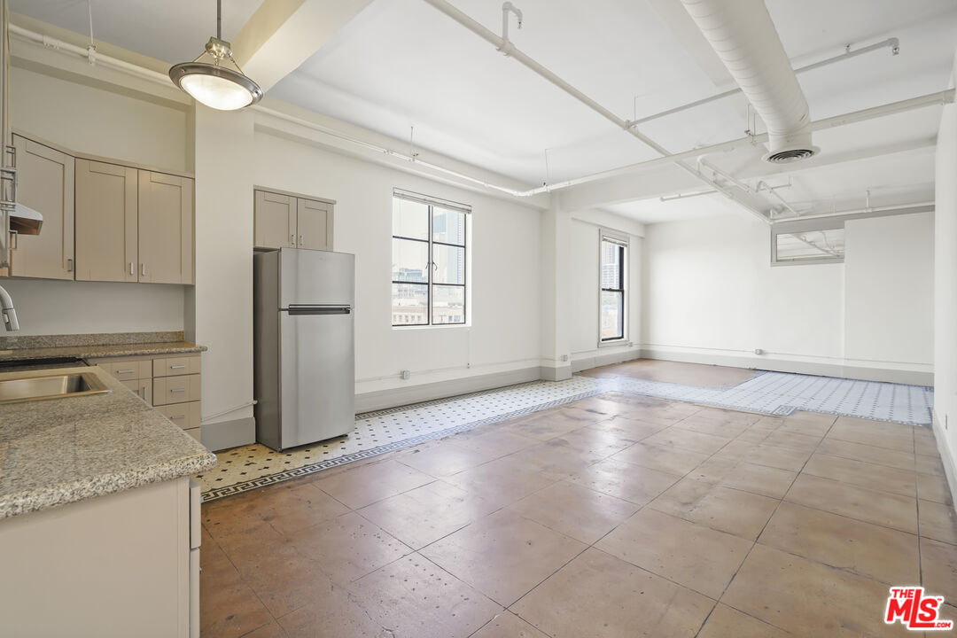 108 West 2nd Street, Unit 708 Los Angeles, CA 90012 - Photo 16 of 40 a view of a kitchen with a sink and a refrigerator