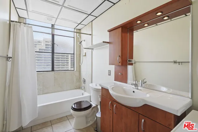 a view of a bathroom with a granite countertop shower