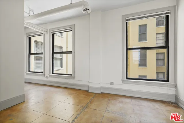 a view of a hallway with a glass door and windows