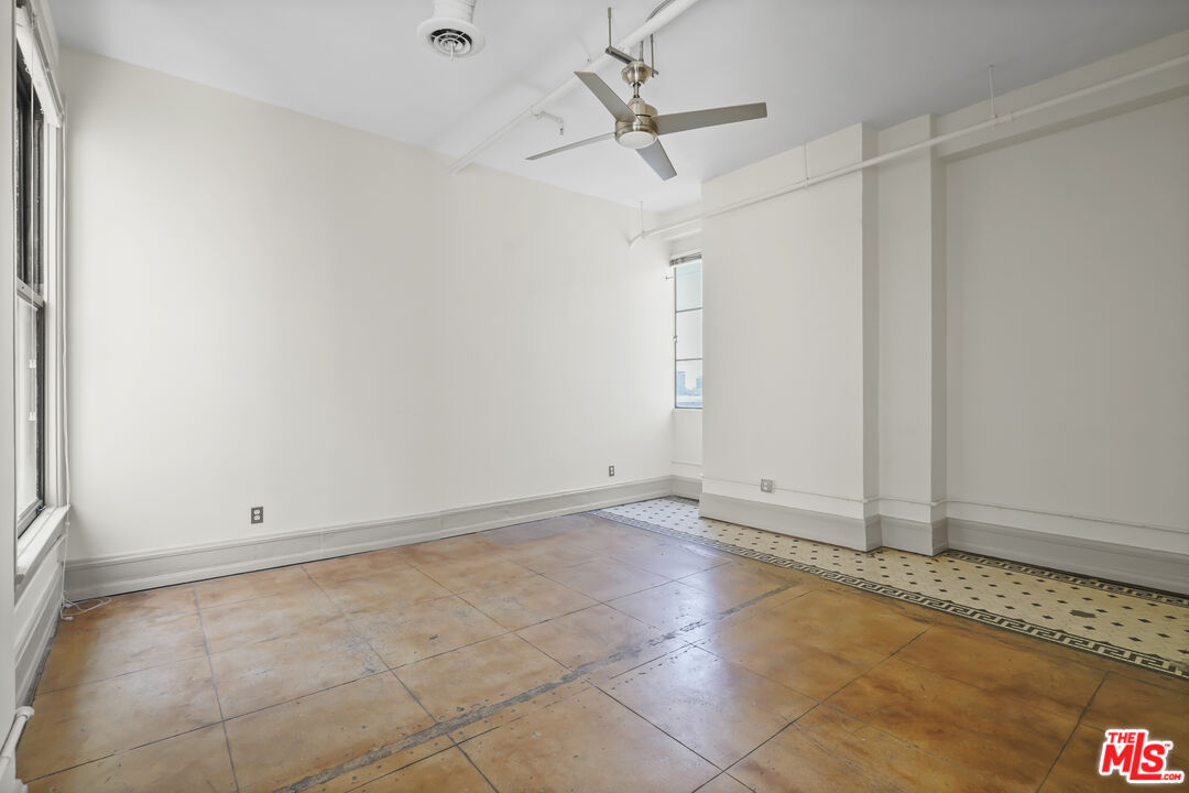 108 West 2nd Street, Unit 708 Los Angeles, CA 90012 - Photo 24 of 40 an empty room with an entryway and chandelier fan