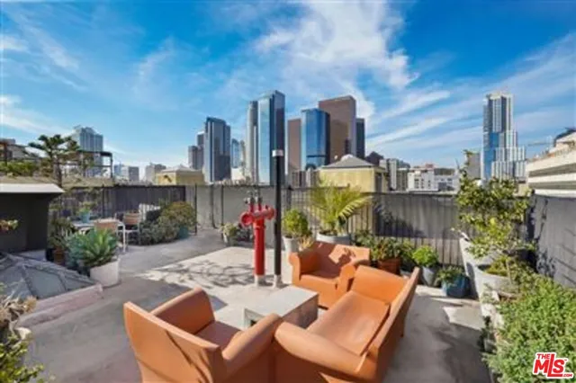 a view of a patio with table and chairs potted plants