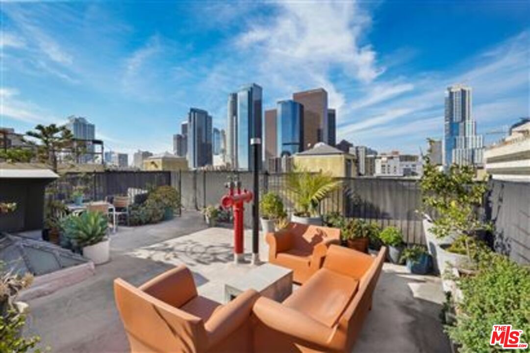 108 West 2nd Street, Unit 708 Los Angeles, CA 90012 - Photo 26 of 40 a view of a terrace with furniture and a fire pit