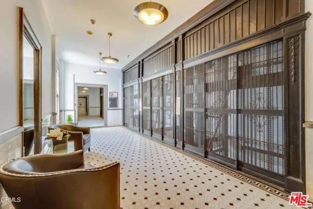 a living room with furniture a chandelier and a rug