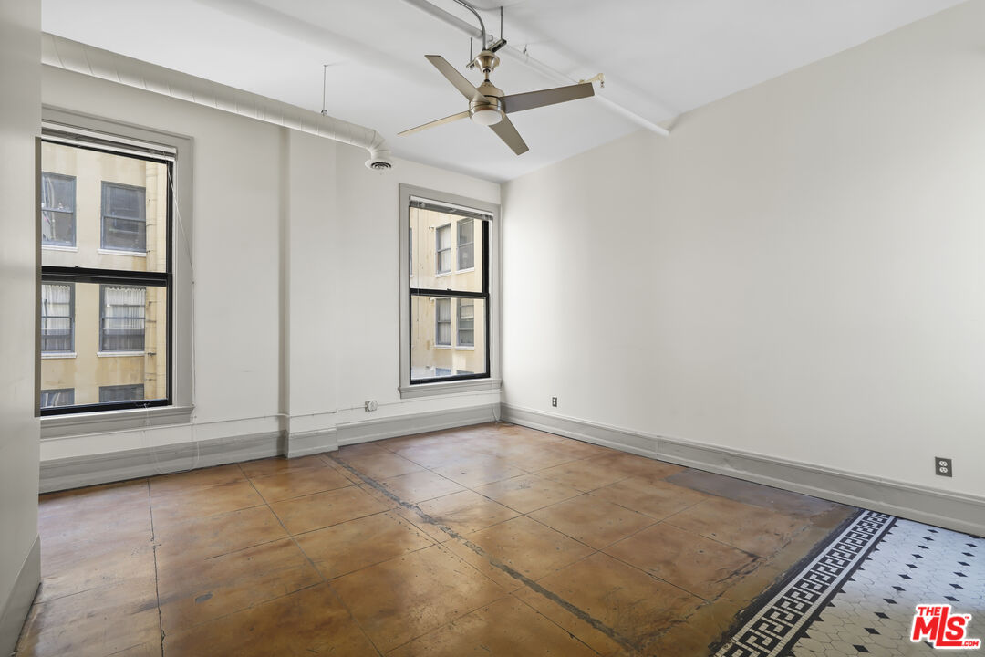 108 West 2nd Street, Unit 708 Los Angeles, CA 90012 - Photo 8 of 40 an empty room with windows and fan