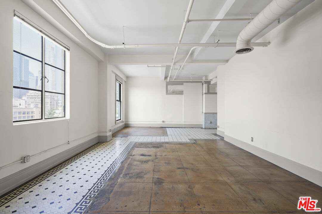 108 West 2nd Street, Unit 708 Los Angeles, CA 90012 - Photo 10 of 40 an empty room with windows