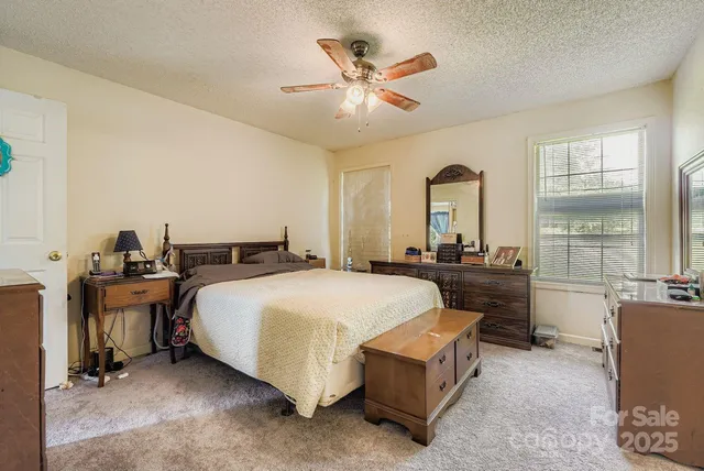 a spacious bedroom with a bed and window